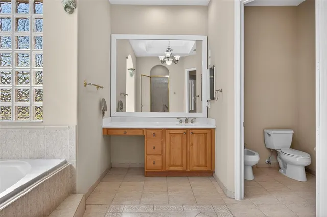 a spacious bathroom with a bathtub sink and toilet