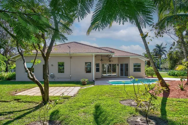 a front view of house with yard and green space