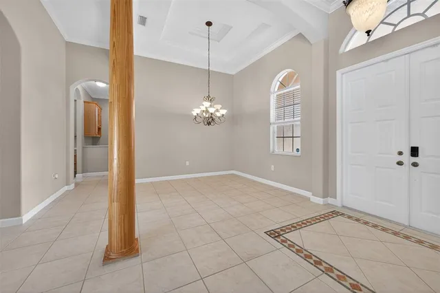 a view of a chandelier fan and entryway