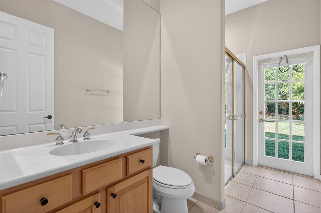 15601 Southwest 15th Street Davie, FL 33326 - Photo 37 of 52 a bathroom with a granite countertop sink toilet and large mirror