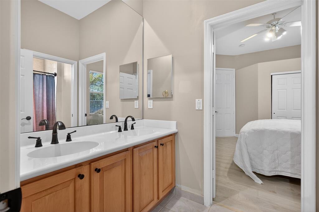 15601 Southwest 15th Street Davie, FL 33326 - Photo 41 of 52 a en suite bathroom with a double vanity sink a mirror and a bathtub