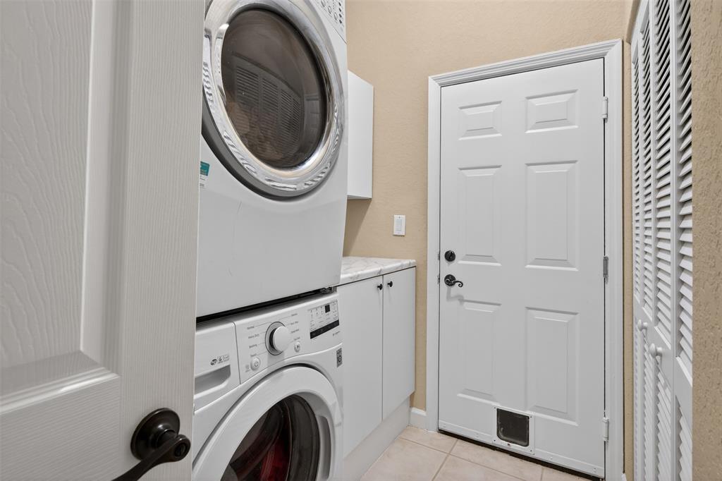 15601 Southwest 15th Street Davie, FL 33326 - Photo 44 of 52 a view of a storage & utility room with dryer and washer
