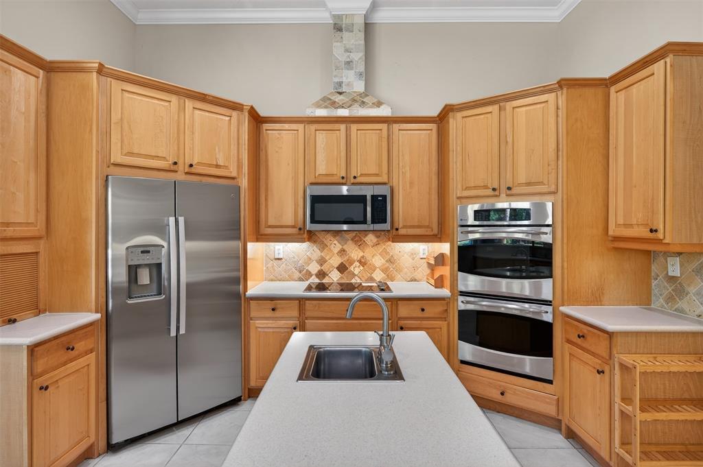 15601 Southwest 15th Street Davie, FL 33326 - Photo 6 of 52 a kitchen with granite countertop a refrigerator and a stove top oven