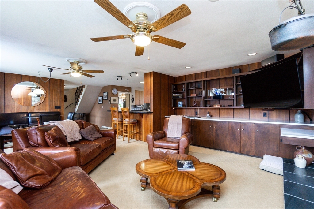 6 Leo Road Marblehead, MA 01945 - Photo 13 of 36 a living room with furniture and a flat screen tv with kitchen view