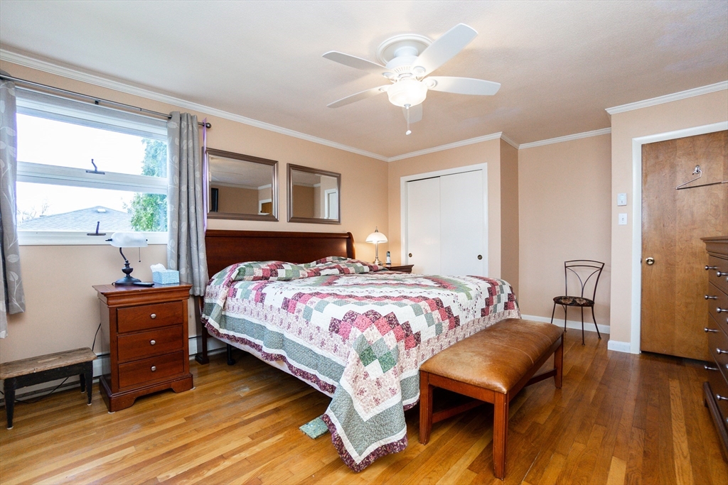 6 Leo Road Marblehead, MA 01945 - Photo 21 of 36 a bedroom with a bed and a chandelier