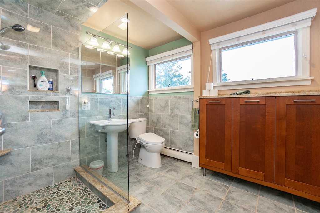 6 Leo Road Marblehead, MA 01945 - Photo 22 of 36 a bathroom with a toilet a sink and glass door