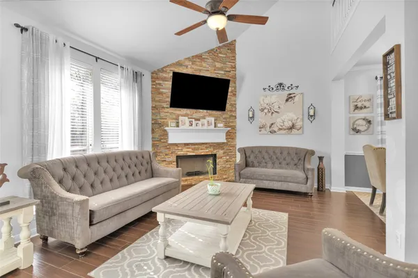 a living room with furniture a flat screen tv and white walls