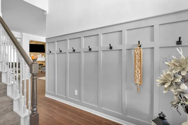 a view of an entryway with wooden floor and door