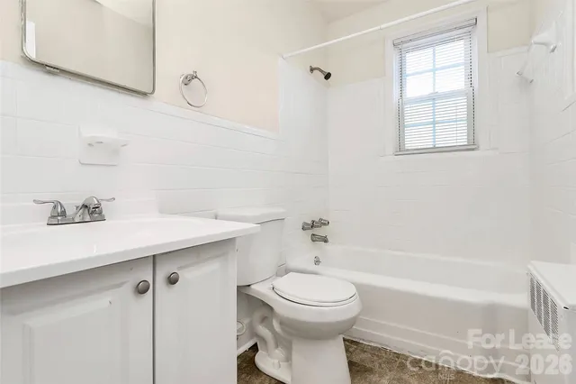 a bathroom with a sink a toilet and bathtub