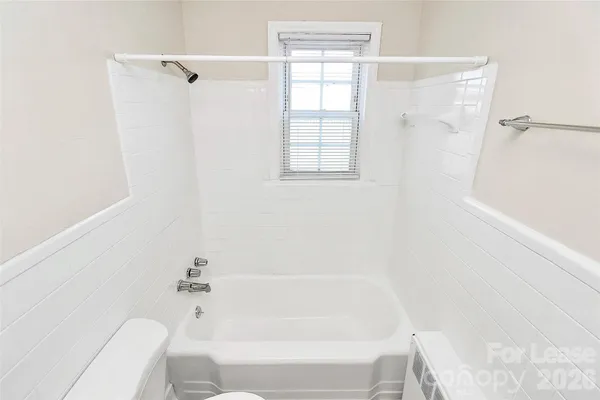 a bathroom with a bathtub and shower