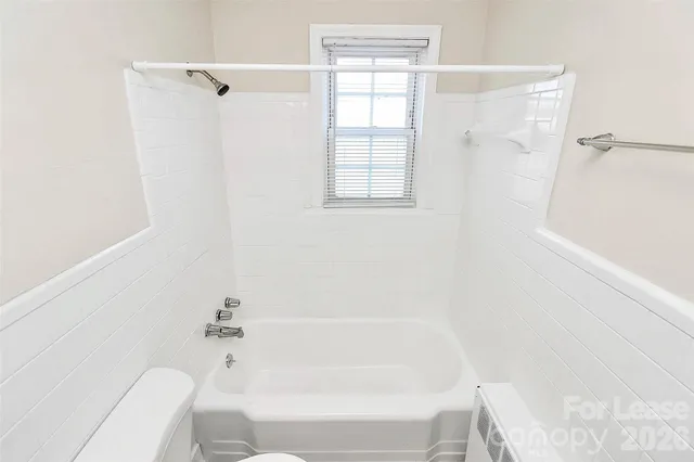 a bathroom with a bathtub and shower