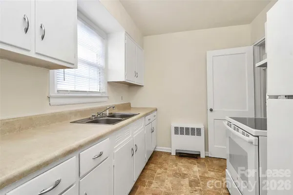 a kitchen with a sink stove and cabinets