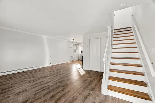 a view of a room with wooden floor and white walls