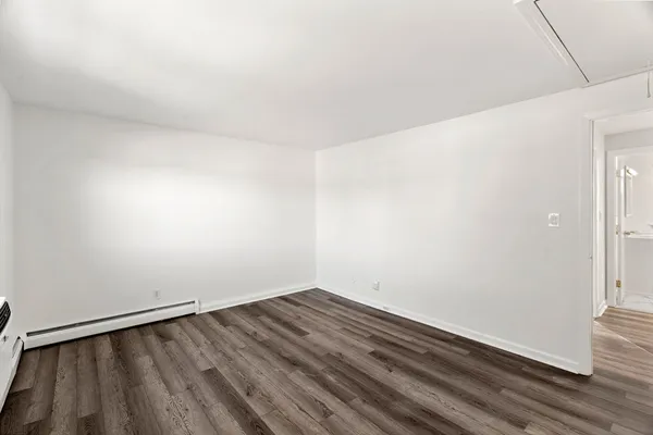 a view of a room with wooden floor