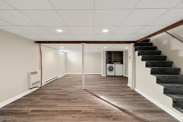 a view of a hallway with wooden floor and entryway