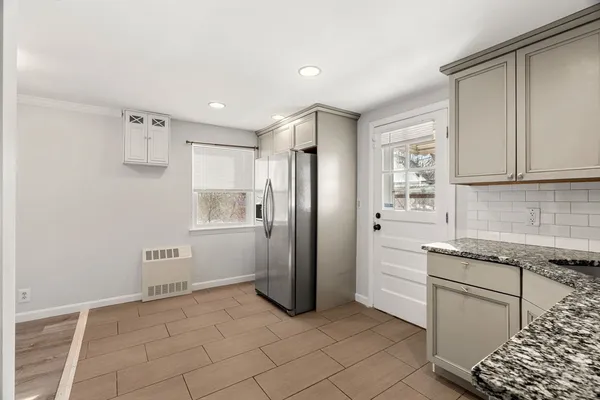 a kitchen with stainless steel appliances granite countertop a refrigerator and a sink