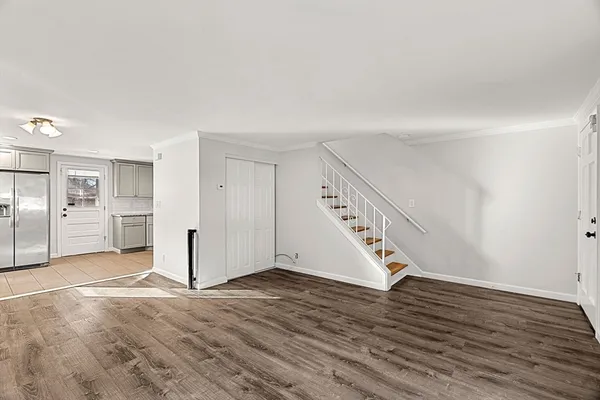 a view of an empty room with wooden floor
