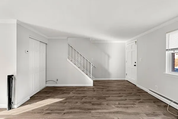 a view of entryway and hall with wooden floor