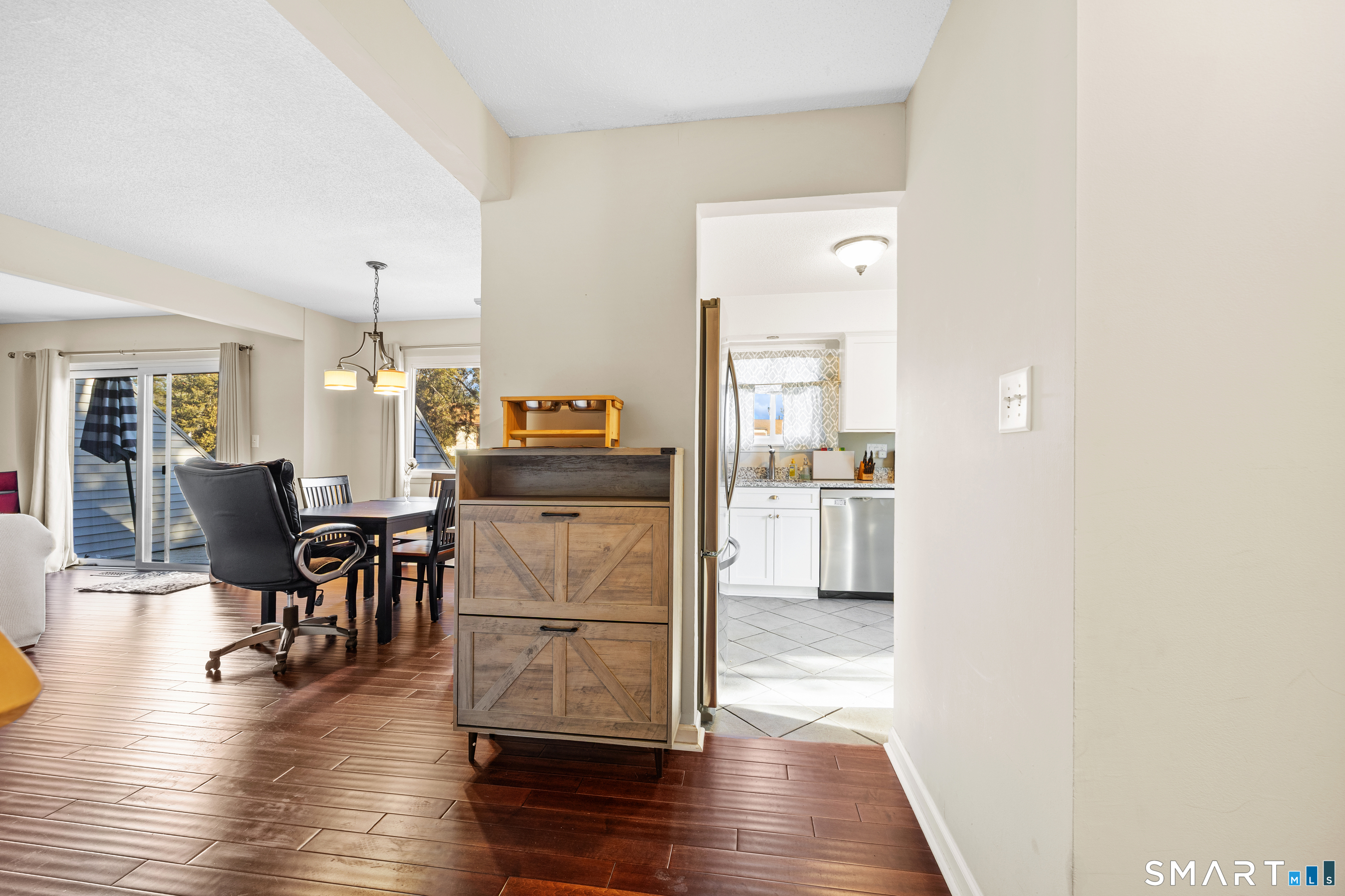 229 Cottonwood Road, Unit 229 Newington, CT 06111 - Photo 12 of 24 a view of kitchen and dining room with wooden floor