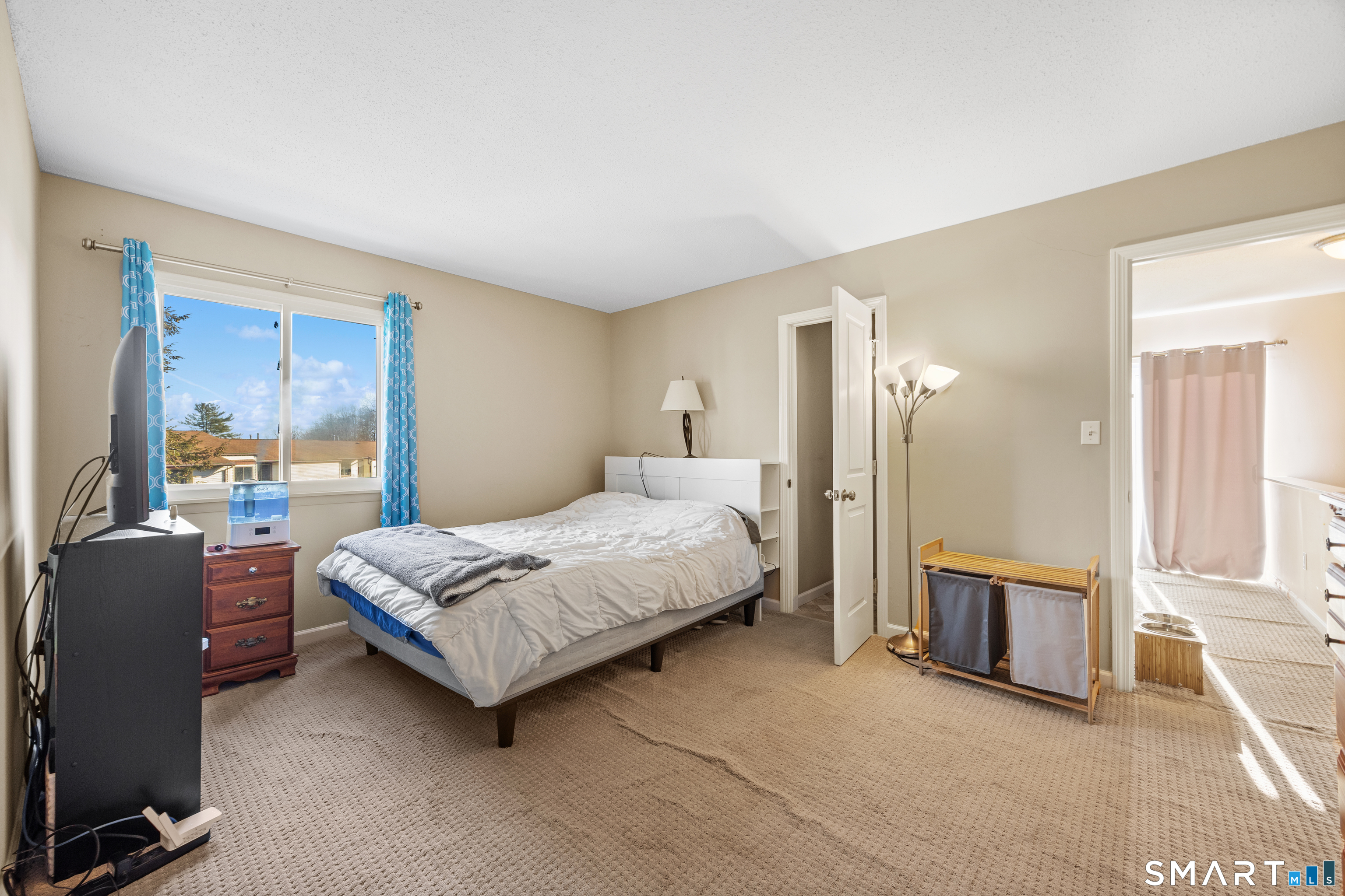 229 Cottonwood Road, Unit 229 Newington, CT 06111 - Photo 14 of 24 a bedroom with a bed couch and a window