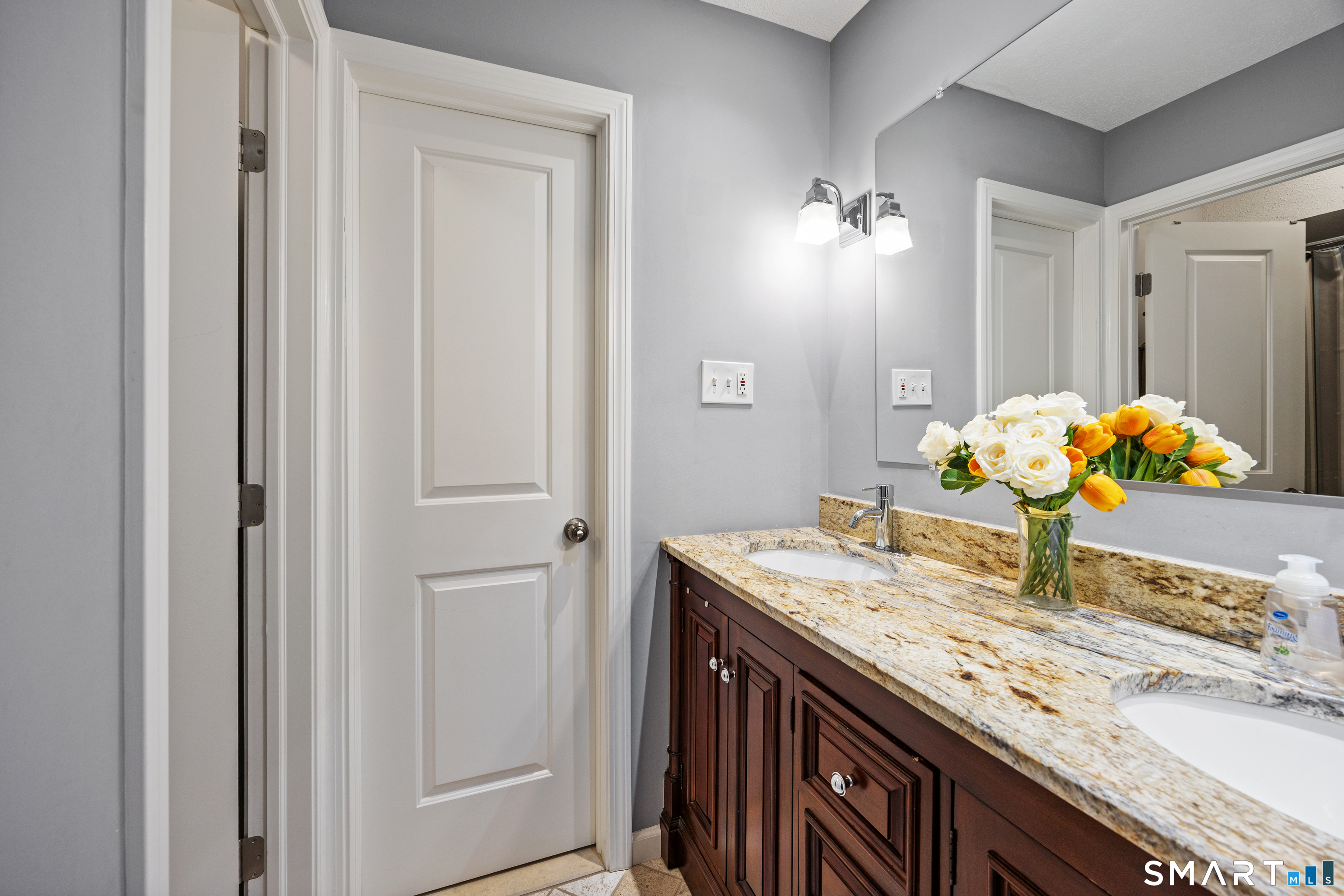229 Cottonwood Road, Unit 229 Newington, CT 06111 - Photo 16 of 24 a bathroom with a granite countertop sink and a mirror