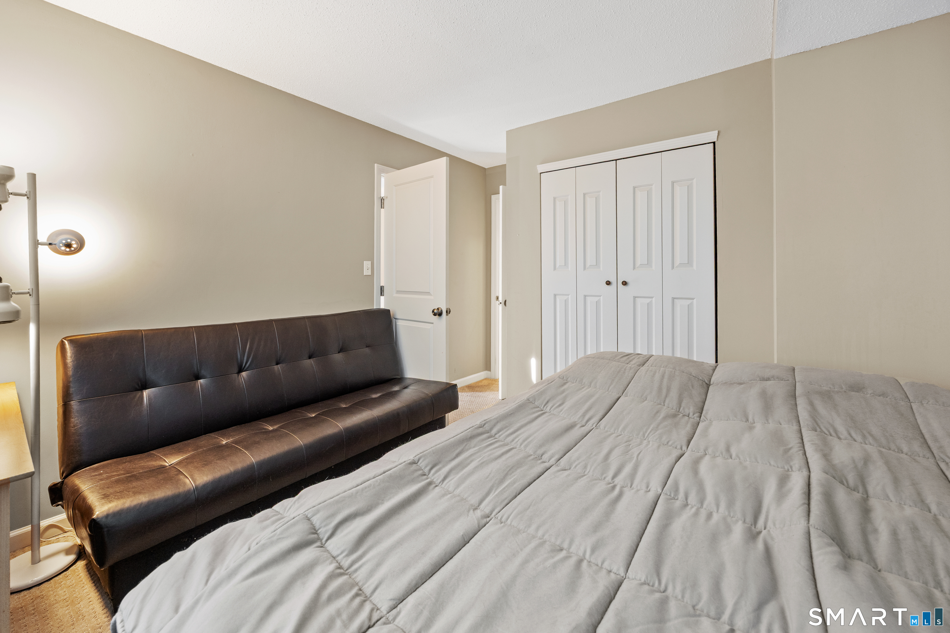 229 Cottonwood Road, Unit 229 Newington, CT 06111 - Photo 18 of 24 a bedroom with a bed couch and a window