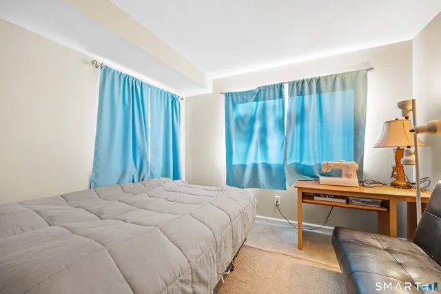 a bedroom with a bed and a furniture