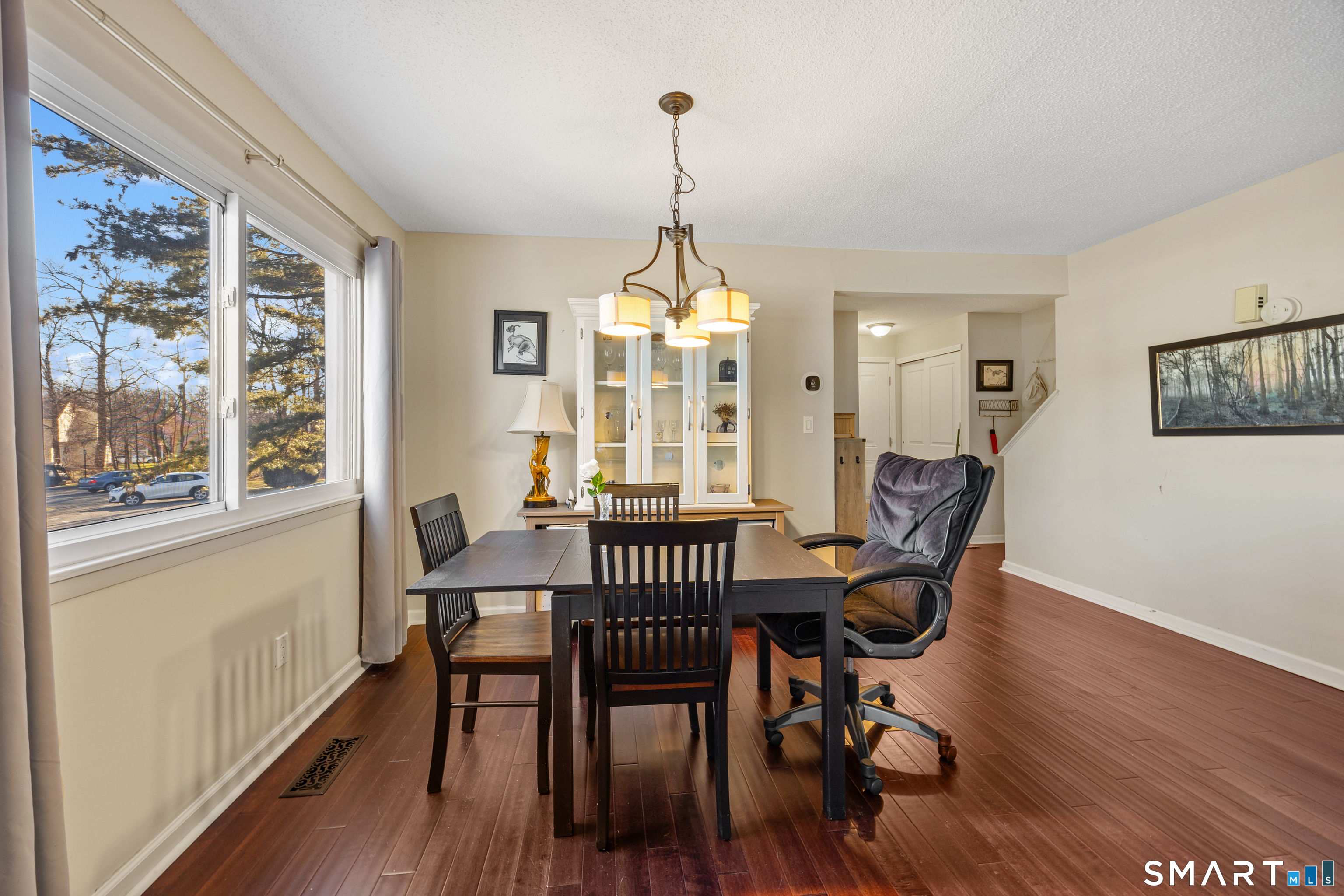 229 Cottonwood Road, Unit 229 Newington, CT 06111 - Photo 4 of 24 a dining room with furniture a chandelier and wooden floor