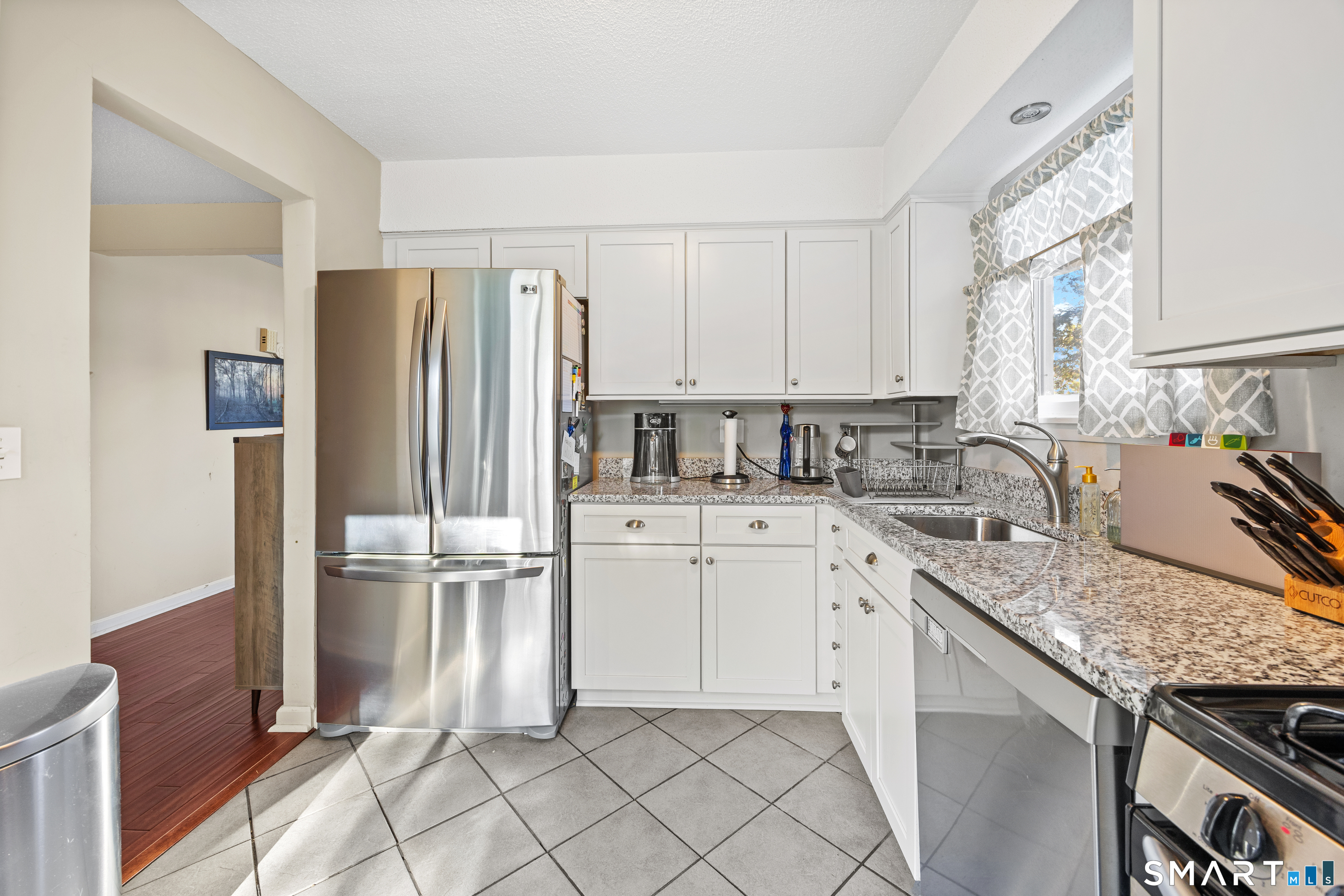 229 Cottonwood Road, Unit 229 Newington, CT 06111 - Photo 6 of 24 a kitchen with stainless steel appliances granite countertop a refrigerator sink and stove