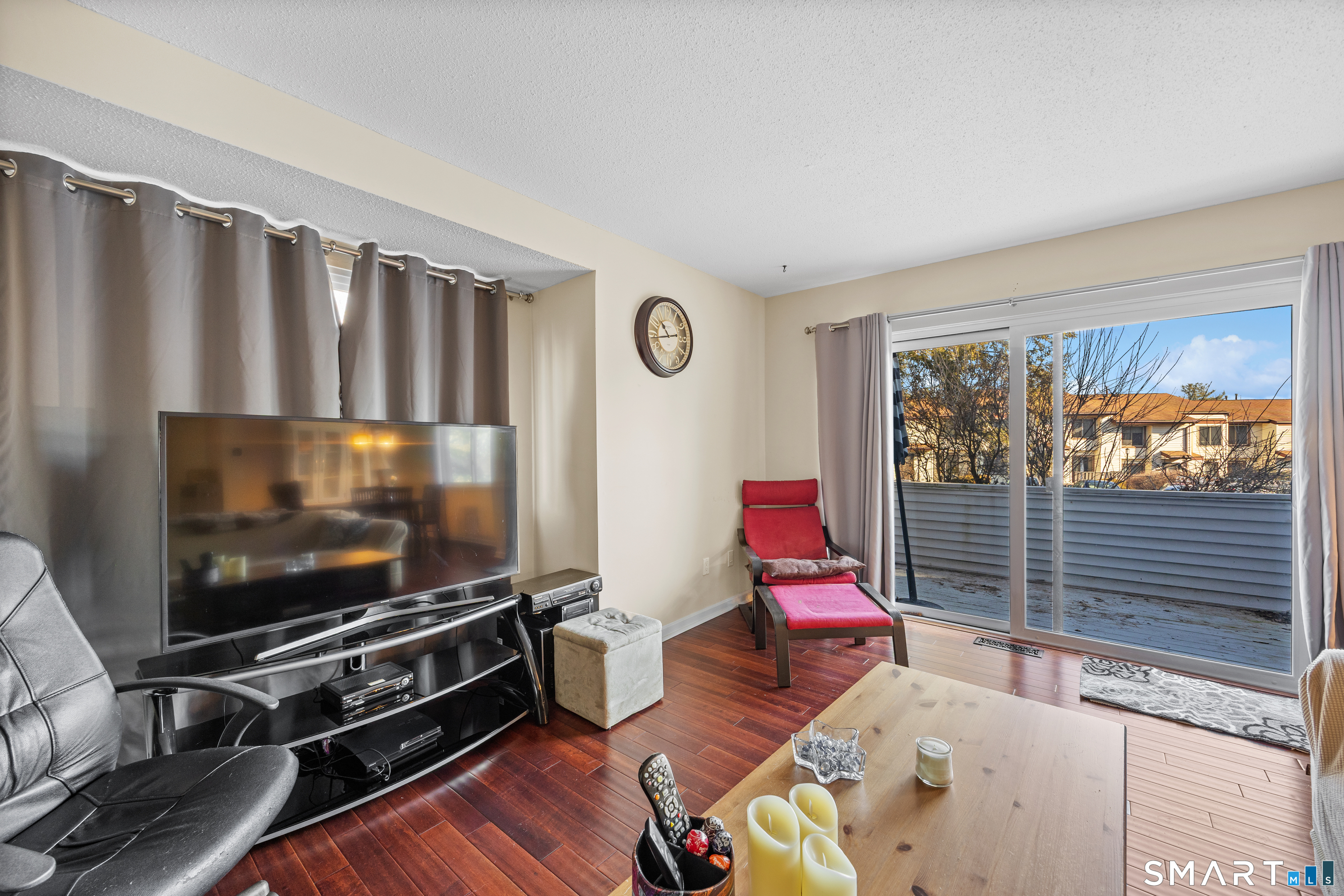 229 Cottonwood Road, Unit 229 Newington, CT 06111 - Photo 8 of 24 a living room with furniture flat screen tv and a large window