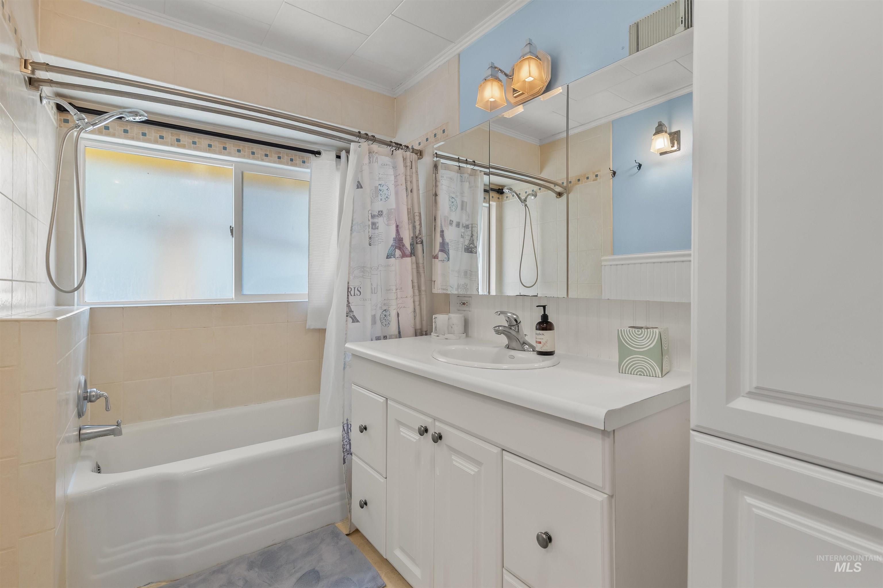 619 Prospect Avenue Lewiston, ID 83501 - Photo 21 of 37 Bathroom featuring a tub/shower combination with tile surround, white vanity with integrated sink, and mirrored medicine cabinet