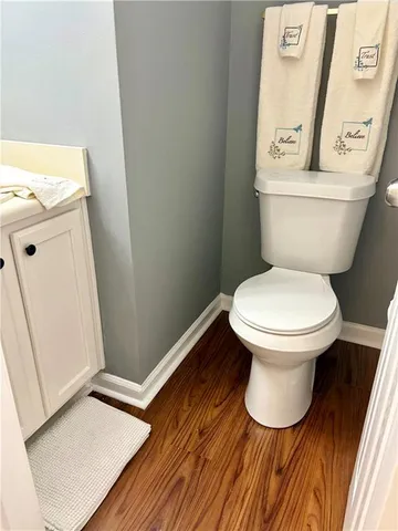 a white toilet sitting next to a bathroom sink