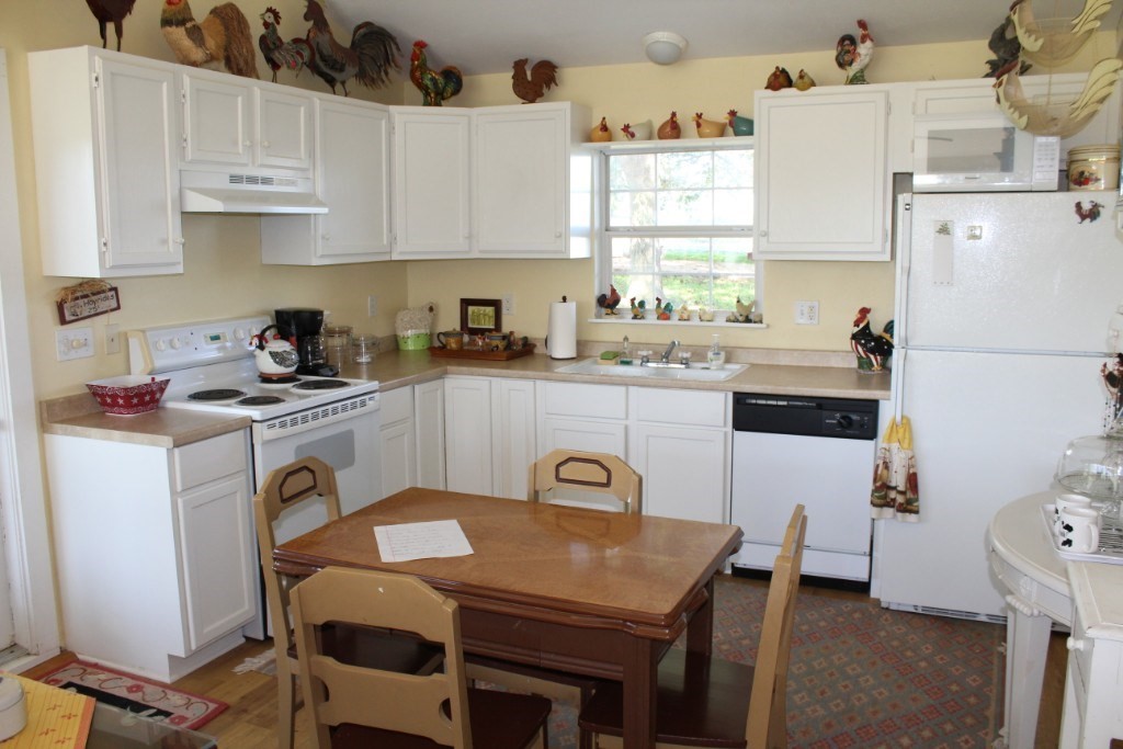 14808 Whitman Road, Unit 2 Washington, TX 77880 - Photo 5 of 11 a kitchen with a white cabinets a stove a sink and white appliances