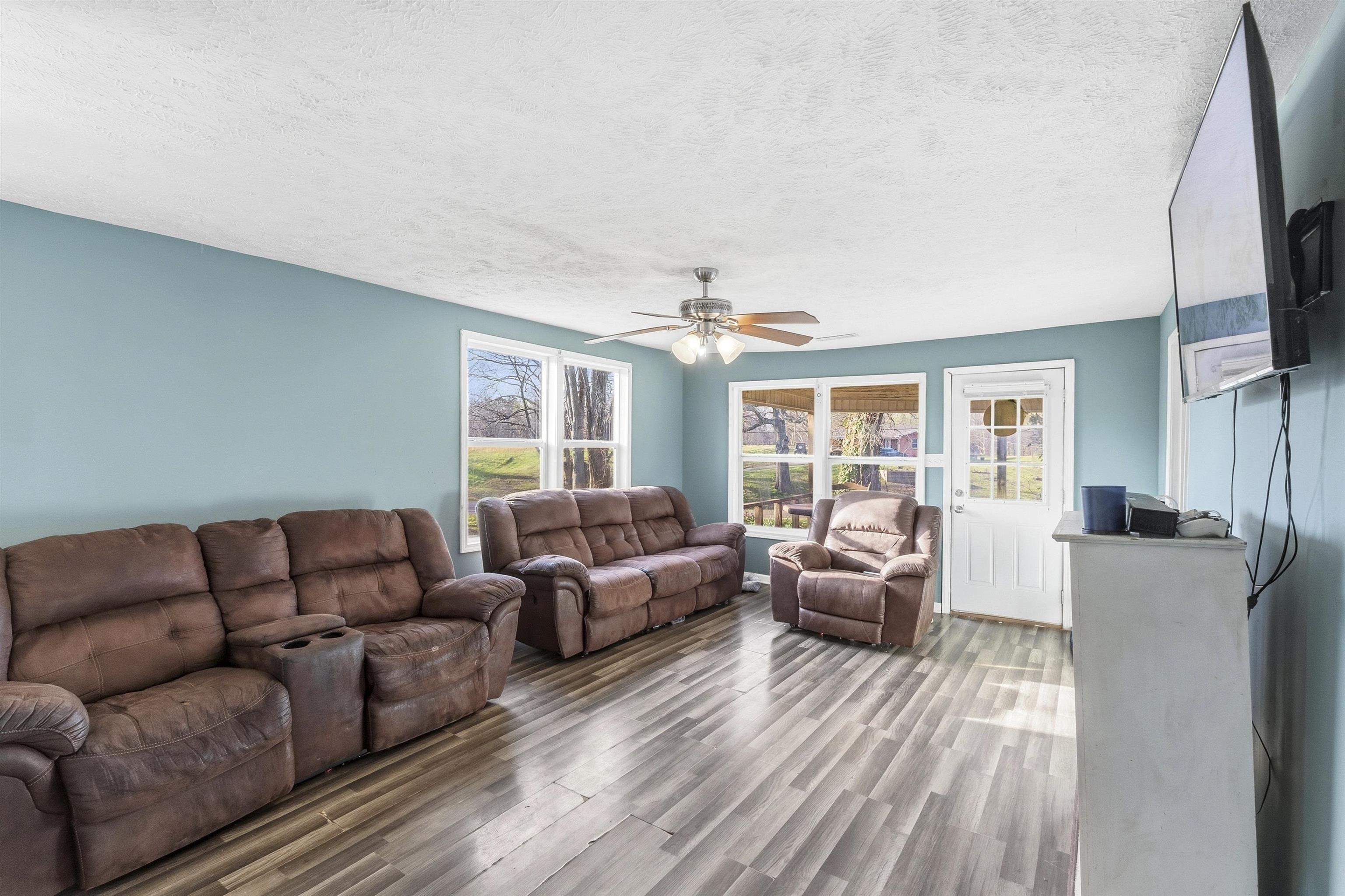 291 Central Curve Road Ripley, TN 38063 - Photo 8 of 13 a living room with furniture a large window and a flat screen tv