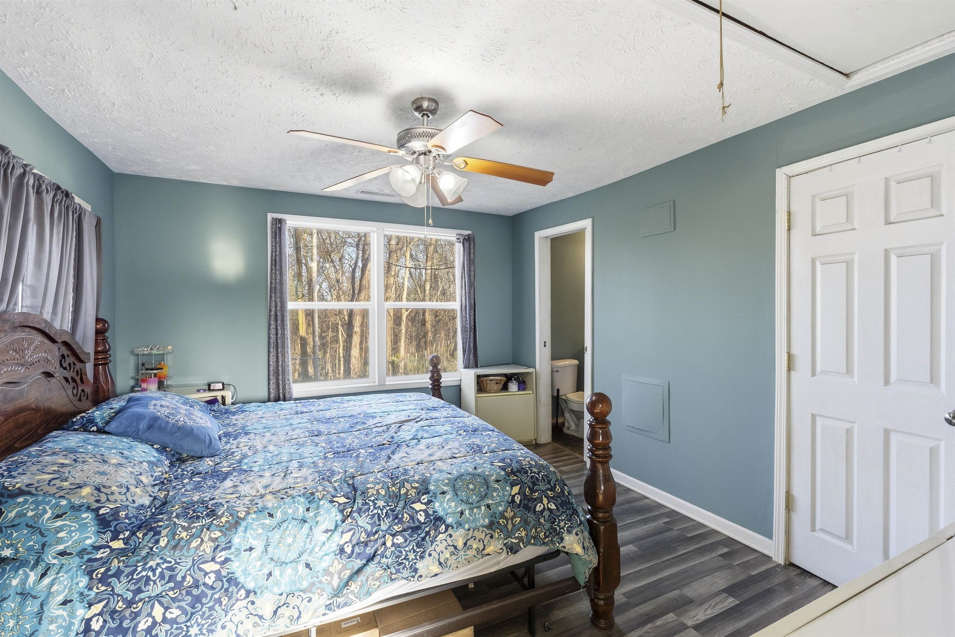 291 Central Curve Road Ripley, TN 38063 - Photo 10 of 13 a bedroom with a bed and a chandelier