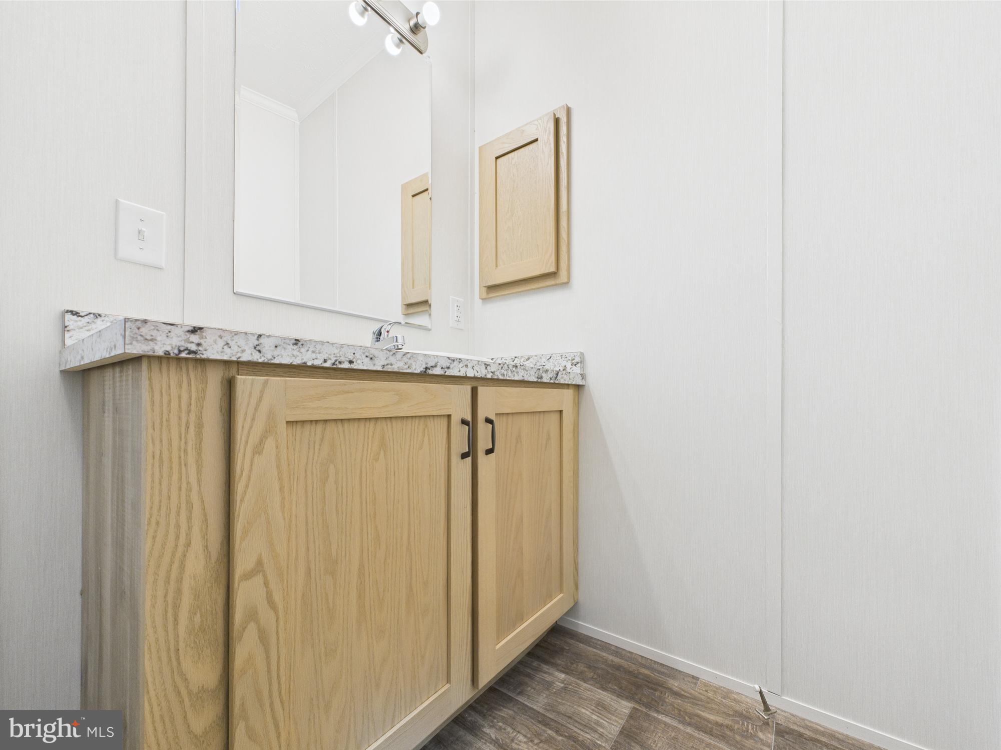 140 Pawnee Avenue Dover, PA 17315 - Photo 24 of 31 a bathroom with a granite countertop sink and a mirror