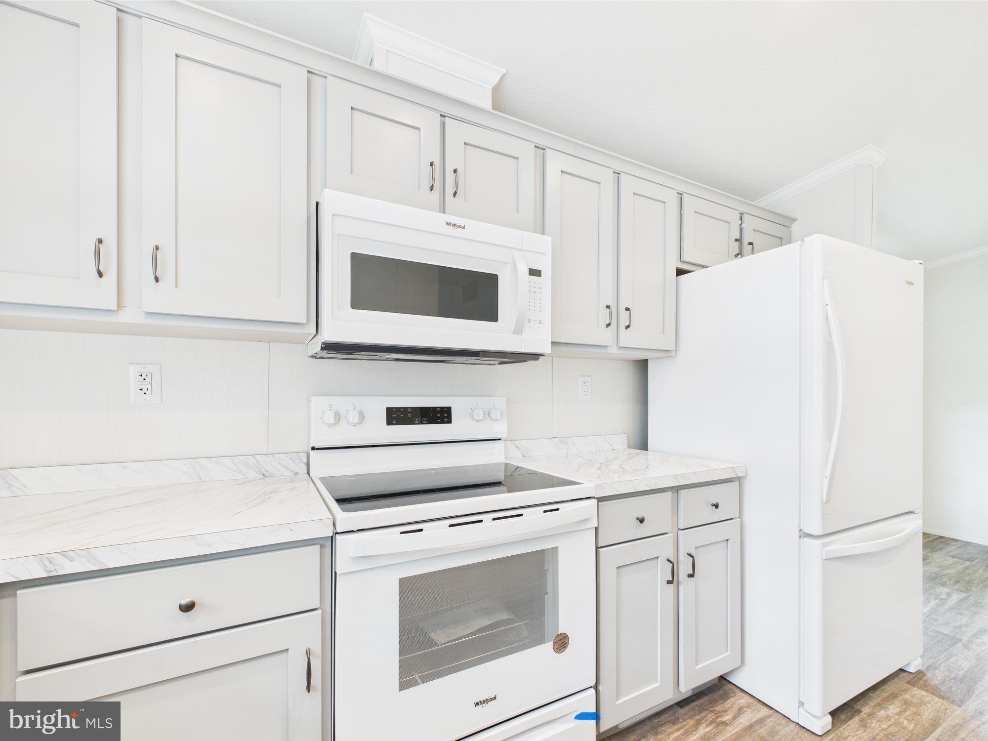 140 Pawnee Avenue Dover, PA 17315 - Photo 4 of 31 a kitchen with white cabinets and white appliances