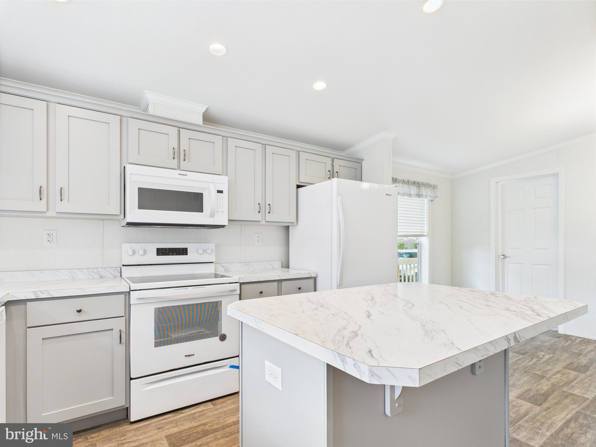 140 Pawnee Avenue Dover, PA 17315 - Photo 5 of 31 a kitchen with stainless steel appliances white cabinets and wooden floor