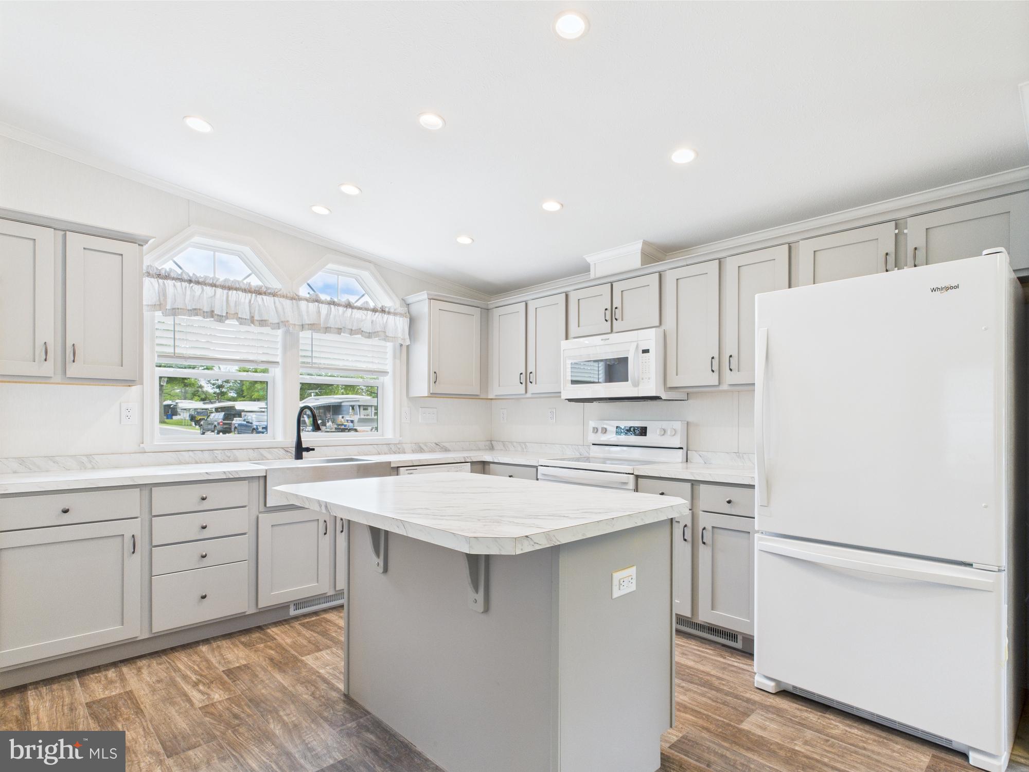 140 Pawnee Avenue Dover, PA 17315 - Photo 7 of 31 a kitchen with a white refrigerator a sink and white cabinets