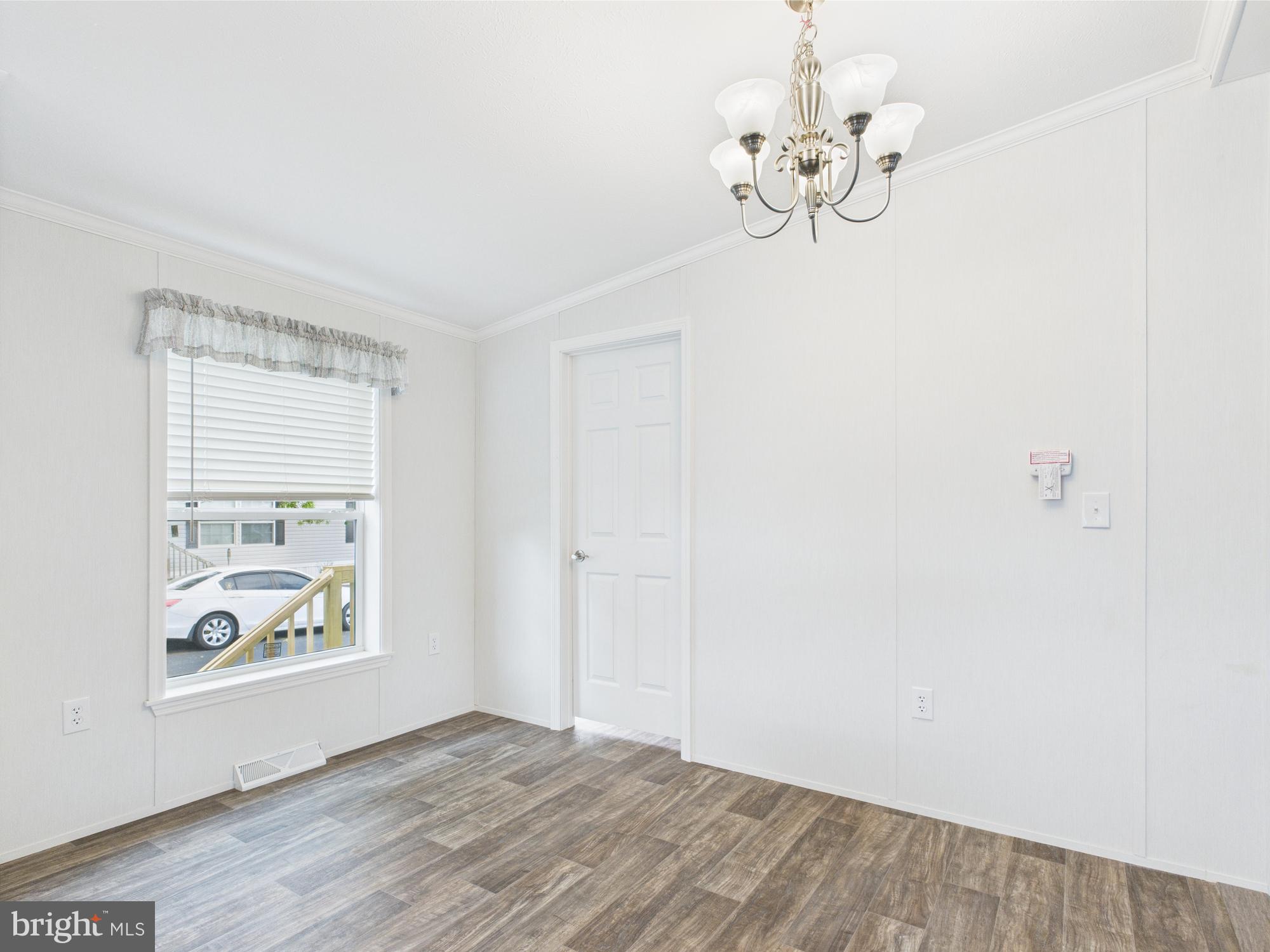 140 Pawnee Avenue Dover, PA 17315 - Photo 9 of 31 a view of an empty room with window and wooden floor
