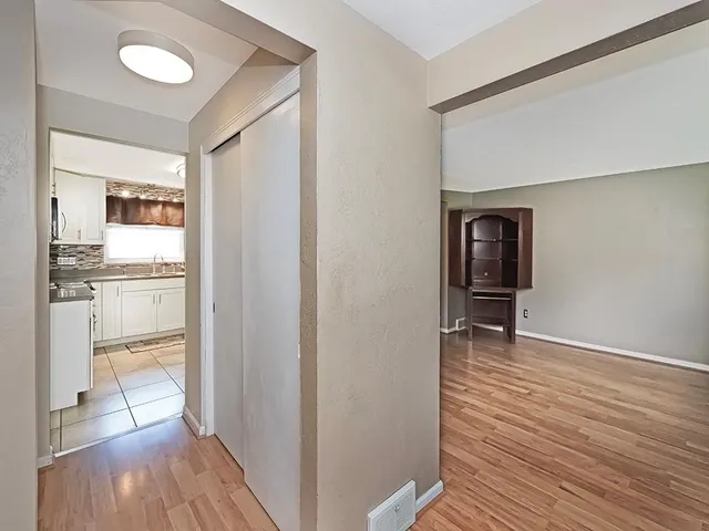 a view of kitchen with sink and refrigerator