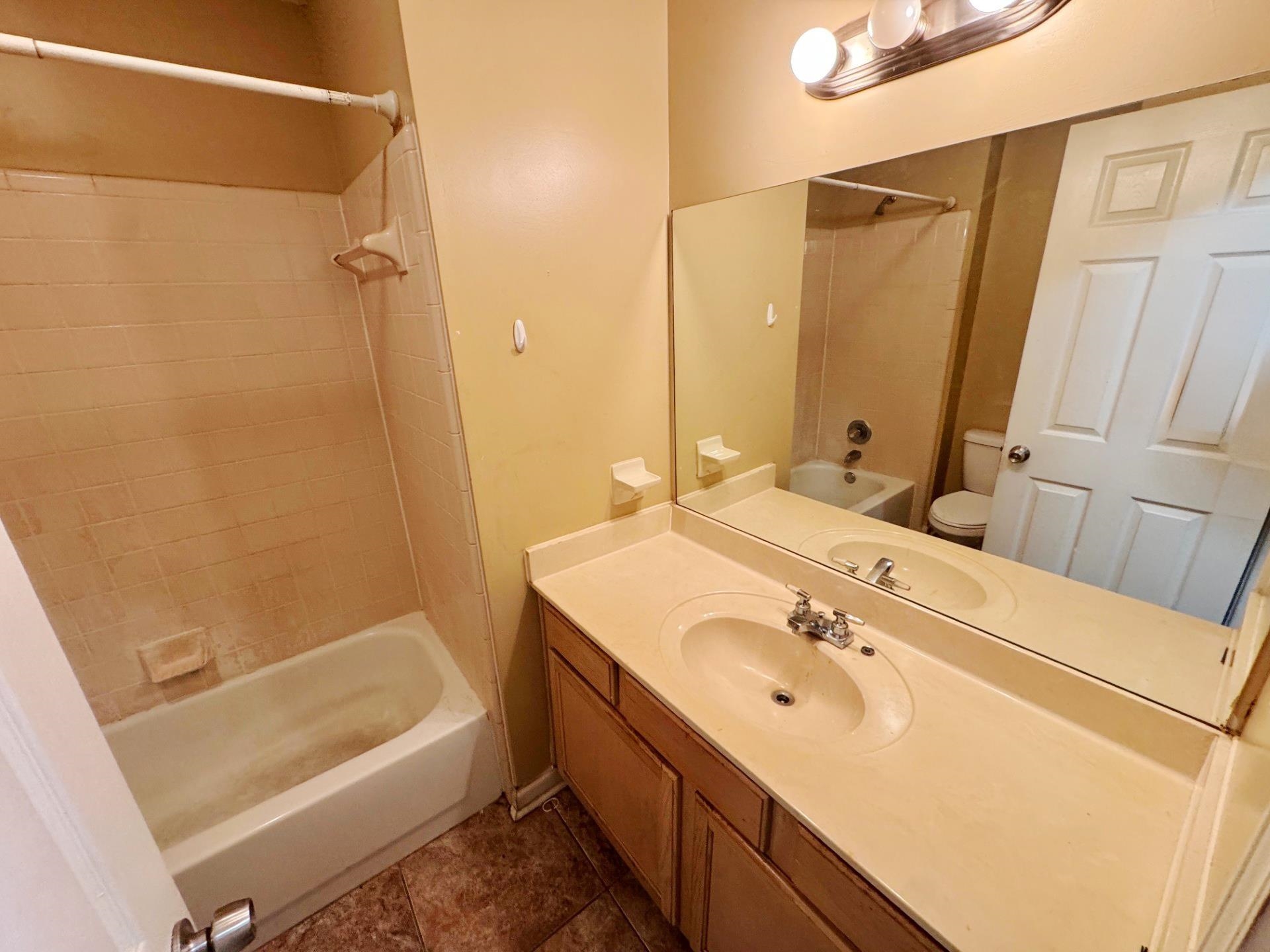 76 Autumn Branch Lane Memphis, TN 38109 - Photo 8 of 13 Full bathroom featuring vanity, tiled shower / bath, and toilet