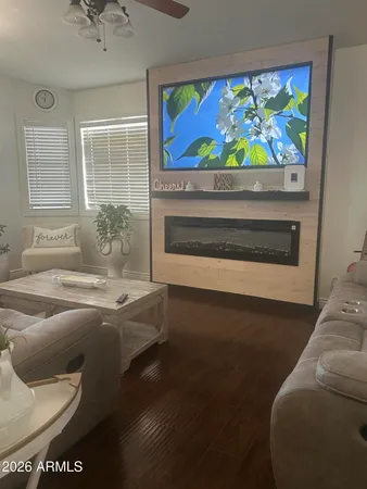a living room with furniture and a floor to ceiling window