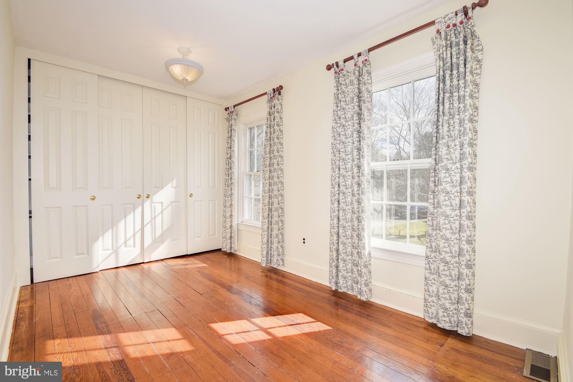 17825 Pond Road Ashton, MD 20861 - Photo 26 of 32 Sunlit bedroom w/ shelved floor to ceiling closet