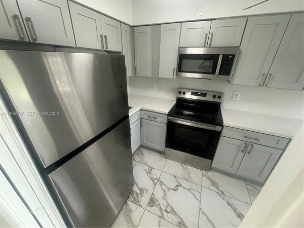 a kitchen with a refrigerator stove and microwave