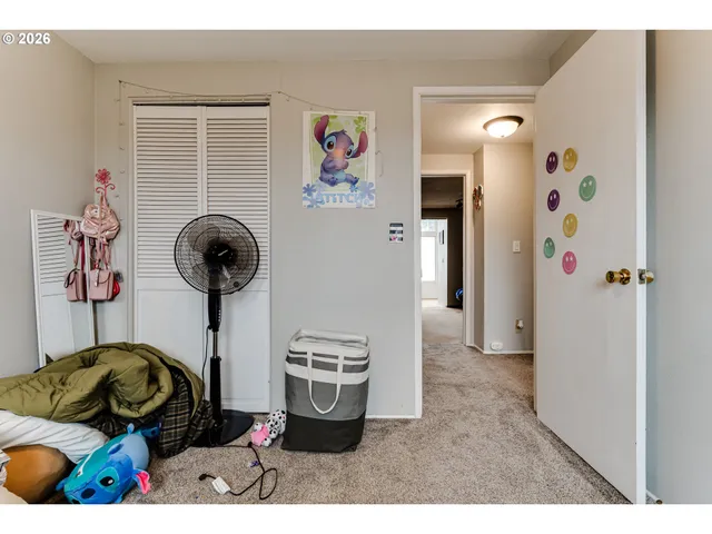 a bedroom with furniture and a fan