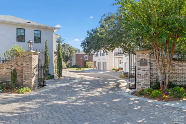 a view of a house with a yard and tree s