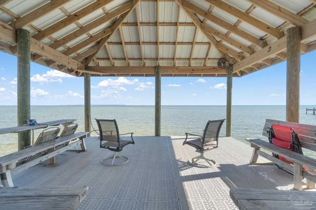 an aerial view of a city with lots of residential buildings ocean and mountain view in back