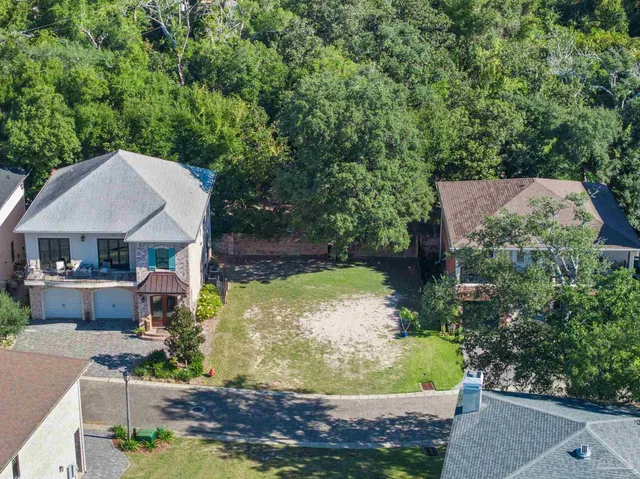 an aerial view of a house with a yard basket ball court and outdoor seating