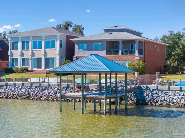 a living room with furniture and floor to ceiling window